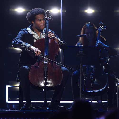 Cellists performing on stage for Paralympics GB team at National Lottery Homecoming Event.